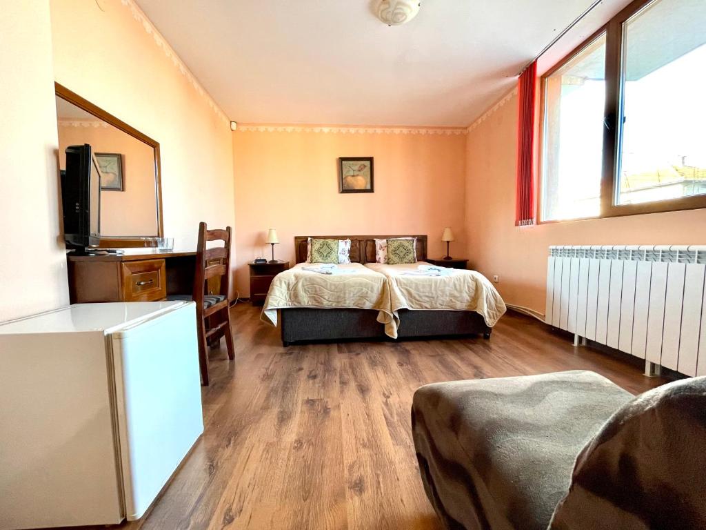 Postel nebo postele na pokoji v ubytování Family Hotel Carpe Diem