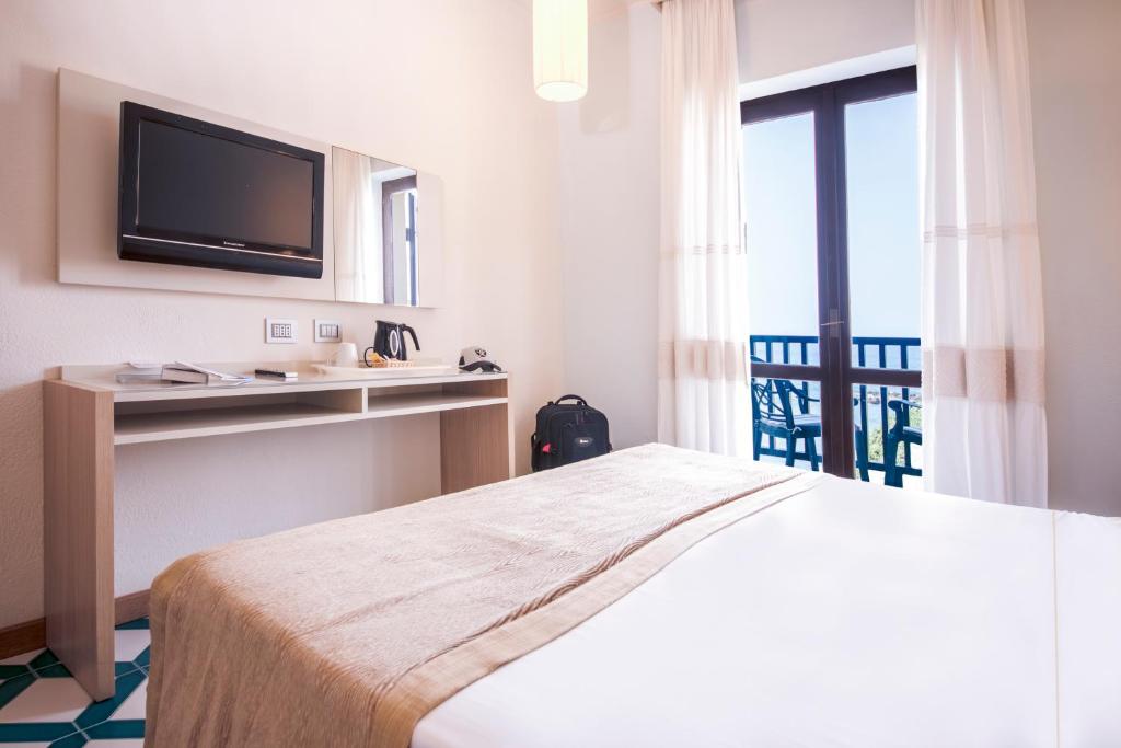Postel nebo postele na pokoji v ubytování Hotel Calabona