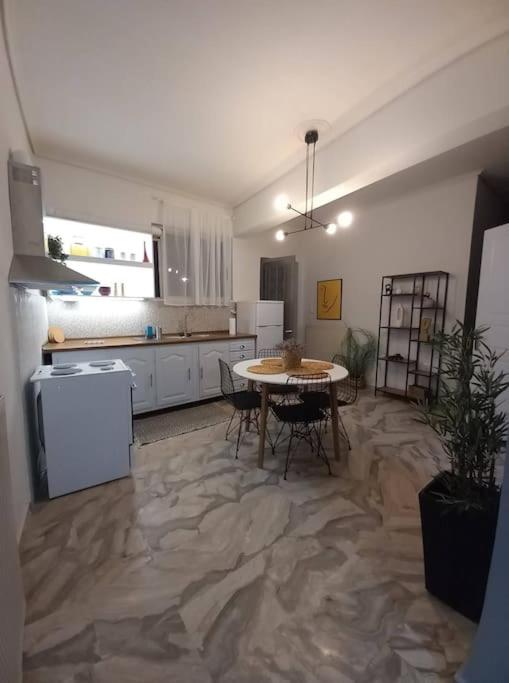 a kitchen with a table and chairs in a room at "Orpheus" - Kalamata Centre in Kalamata