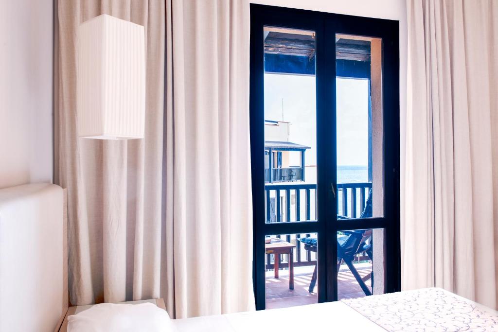 Postel nebo postele na pokoji v ubytování Hotel Calabona