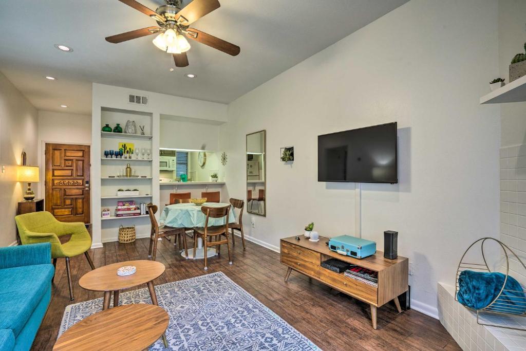 a living room with a blue couch and a tv at Graham Haus River Condo Walk to Schlitterbahn! in New Braunfels