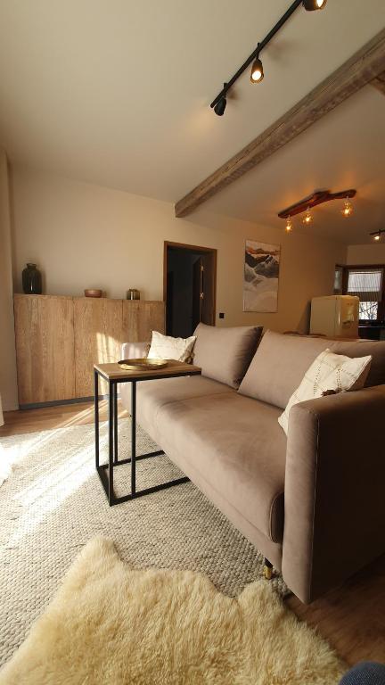 a living room with a couch and a table at KOKICHE 4 Friends, Borovets in Borovets