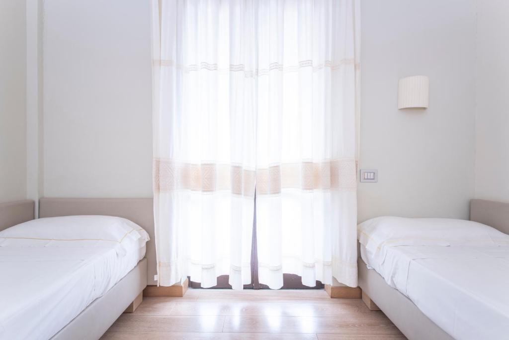 Postel nebo postele na pokoji v ubytování Hotel Calabona