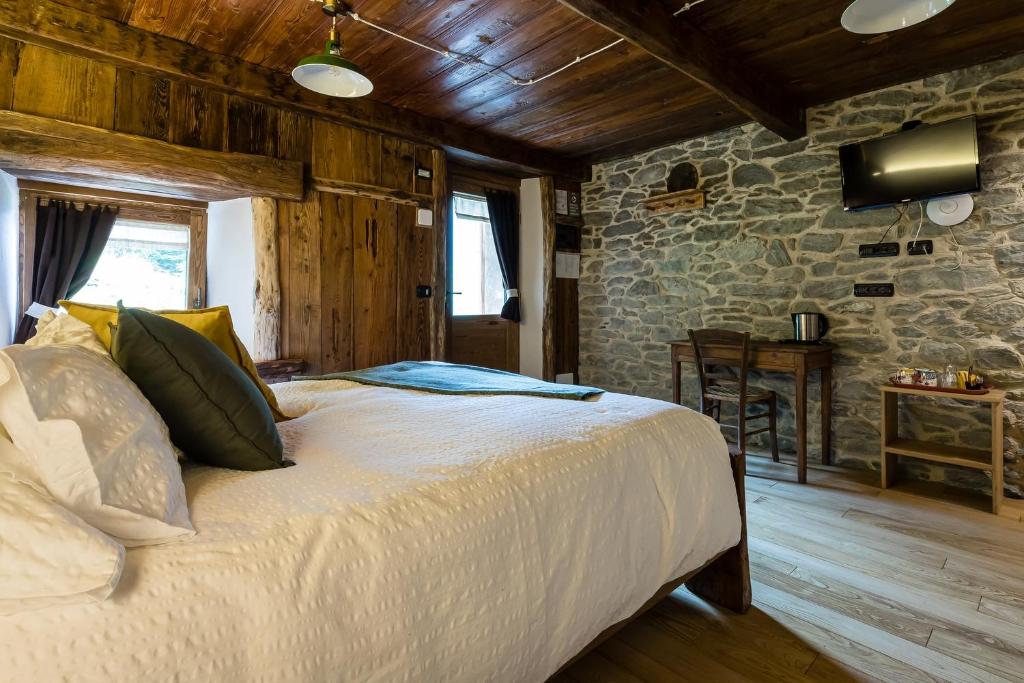 Postel nebo postele na pokoji v ubytování Chambres d'Hôtes - Li Tzatagni