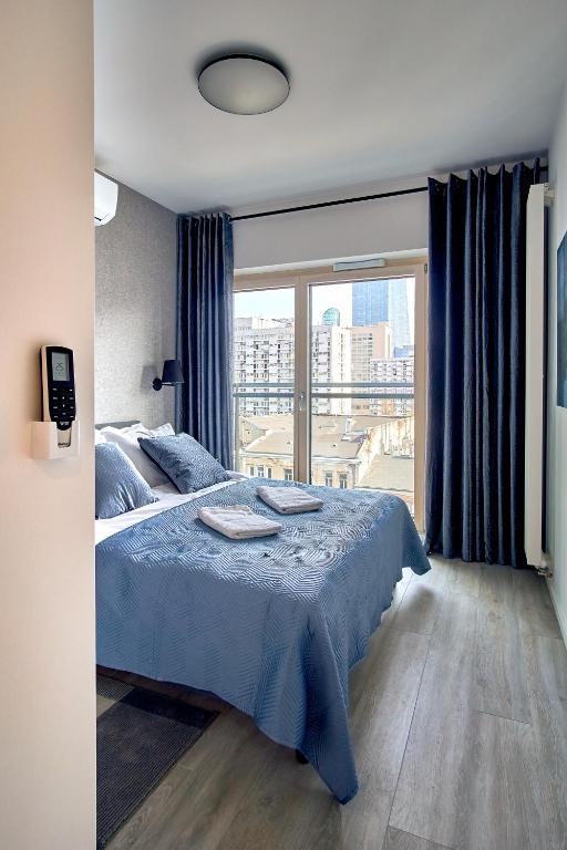 Posteľ alebo postele v izbe v ubytovaní Mennica Residence Deluxe