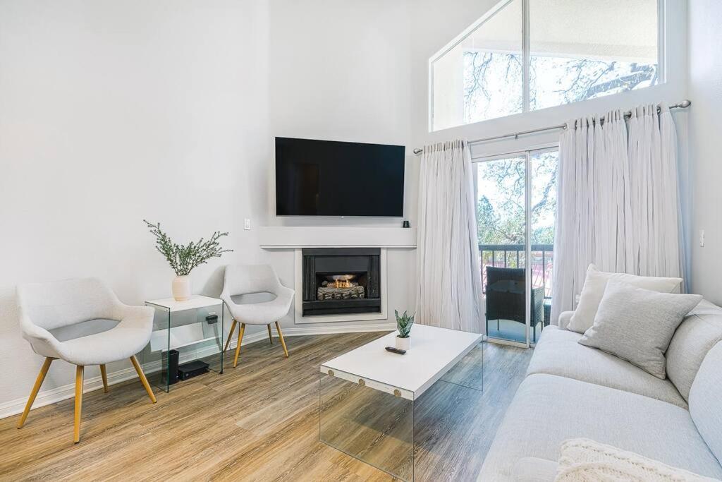 a living room with a couch and a fireplace at Resort-like luxurious condo in Woodland Hills, Los Angeles, Pool, Hot-tub, and more in Woodland Hills
