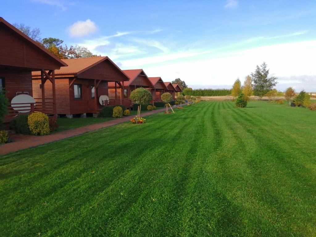 a large yard with a house and green grass at Zielona Polana 