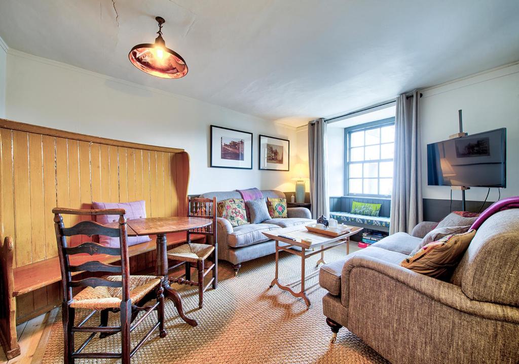 a living room with a couch and a table at The Rock House - Terrace Apartment - in Heart of the City in Edinburgh