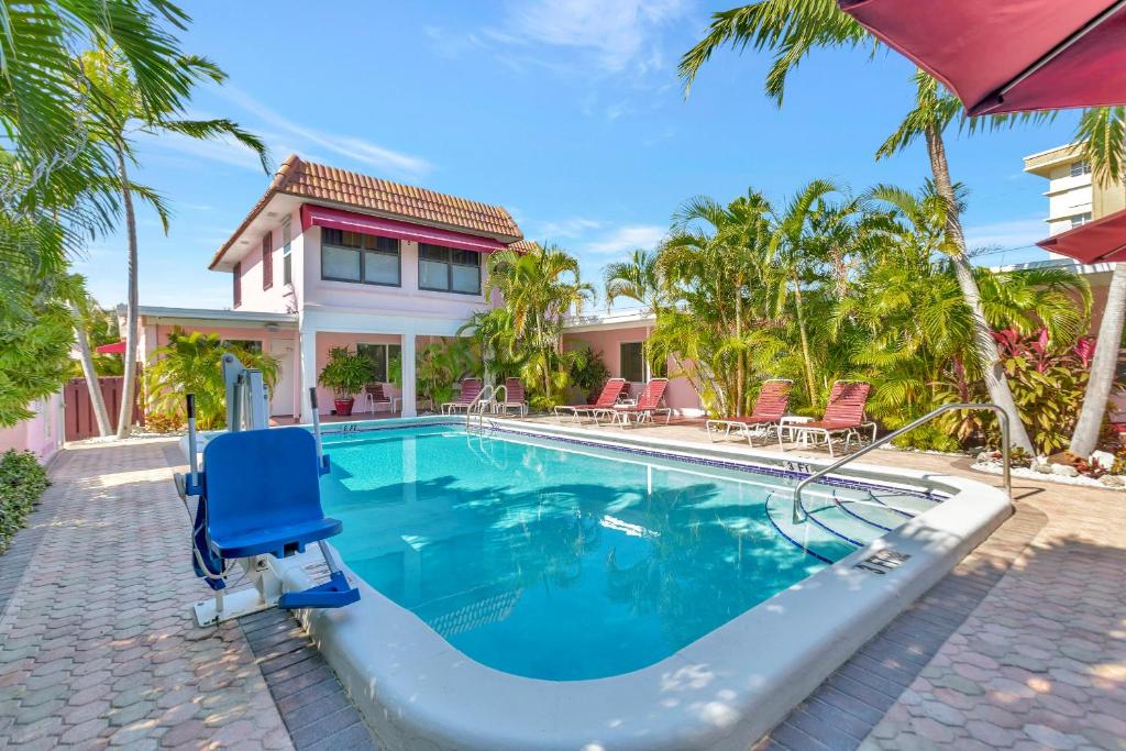 a swimming pool in front of a house at Seahorse Guesthouse in Pompano Beach