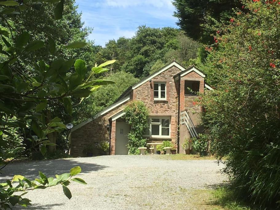 a brick house with a driveway in front of it at The Coach House at Lower Coombe Royal- Family/Dogs in Kingsbridge