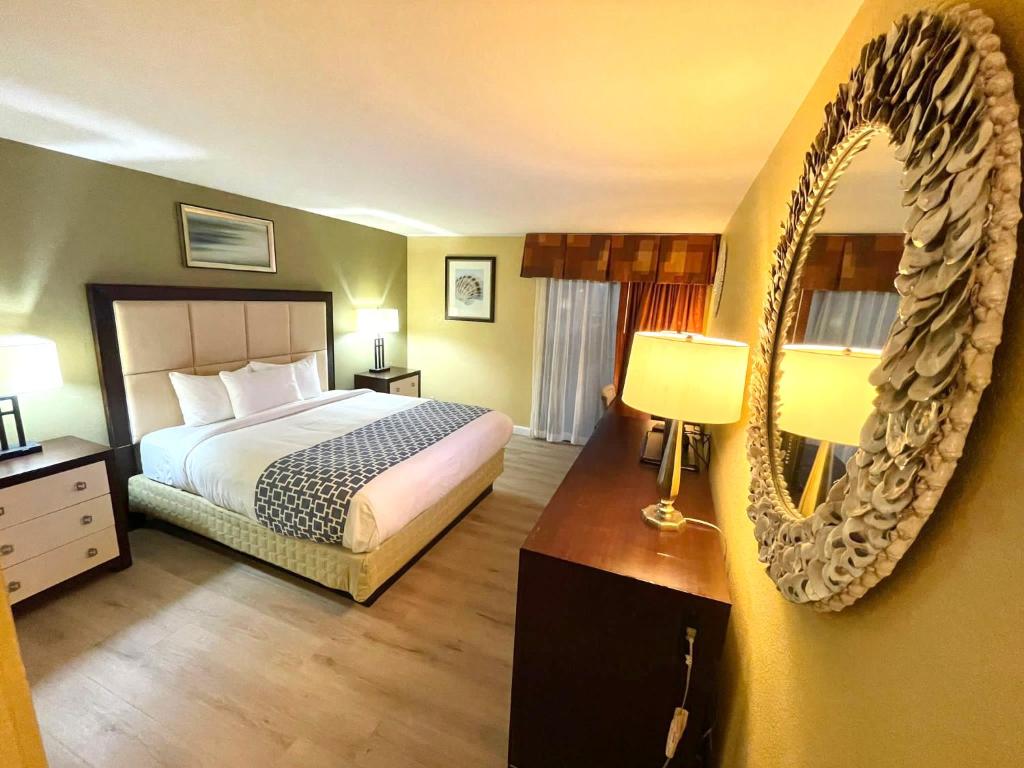 una camera d'albergo con letto e specchio di HUTCHI BELL a South Hutchinson