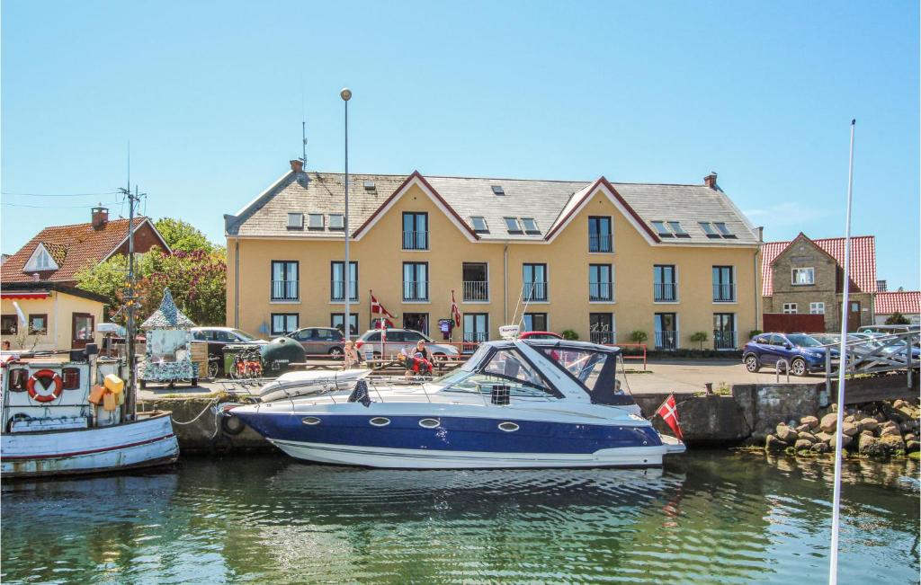 two boats are docked in a marina in front of a building at Beautiful Apartment In Sams With House Sea View in Ballen