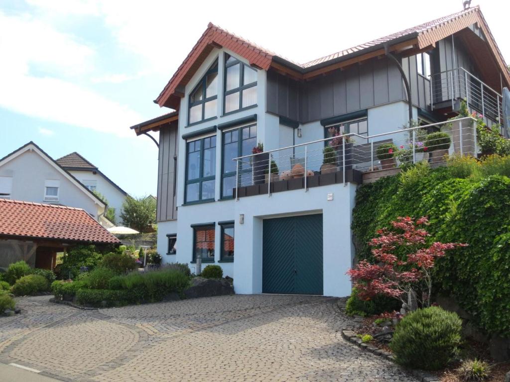 a house with a balcony and a driveway at Property in Daun in Daun