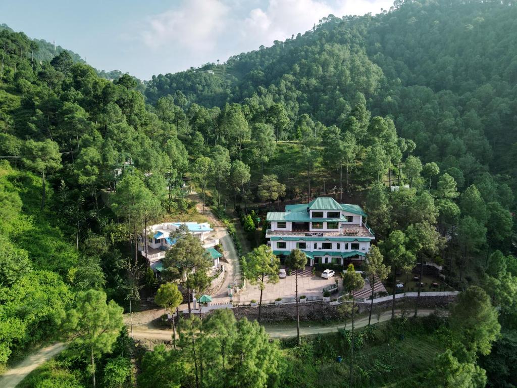 an aerial view of a house in the forest at Pineland Resorts & Chalets Kasauli in Kasauli