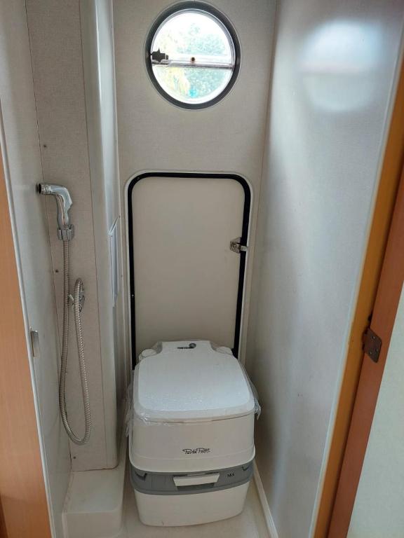 a small bathroom with a toilet and a window at ABCDEF g in Klang