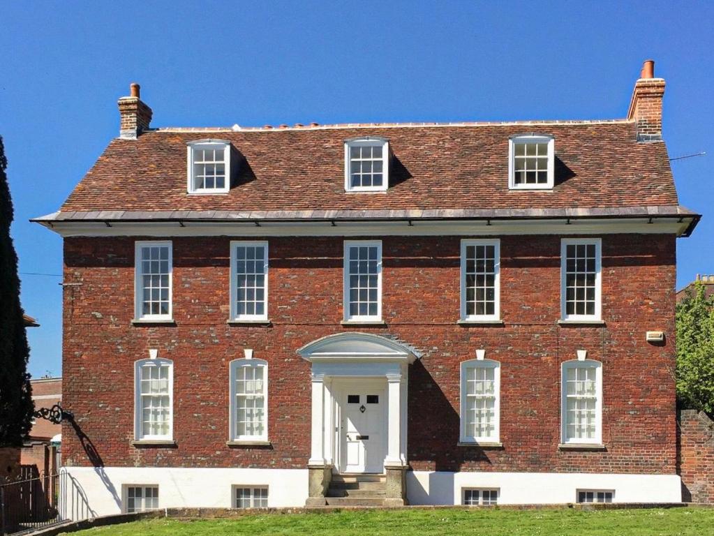 a large red brick building with a white door at Beautiful Georgian House located in Blandford in Blandford Forum