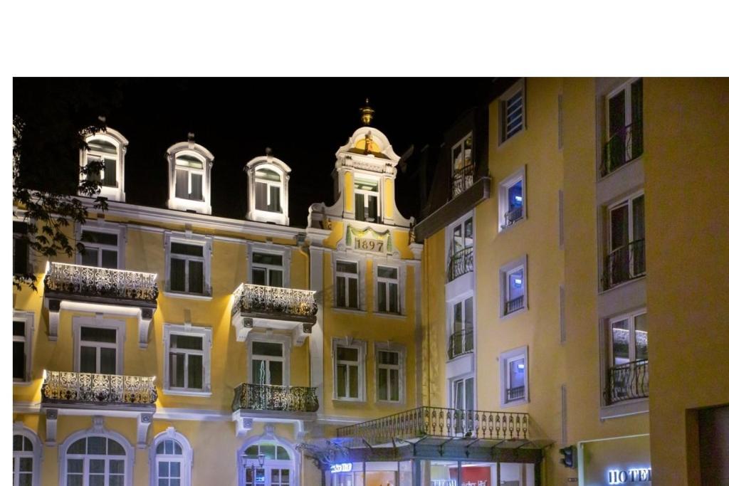 a building with a clock tower on top of it at Milbor Hotel in Bad Soden am Taunus