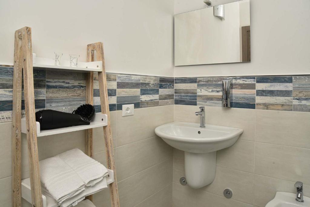 a bathroom with a sink and a mirror at Villa Caravaggio Comfort e Relax in Rocca San Giovanni