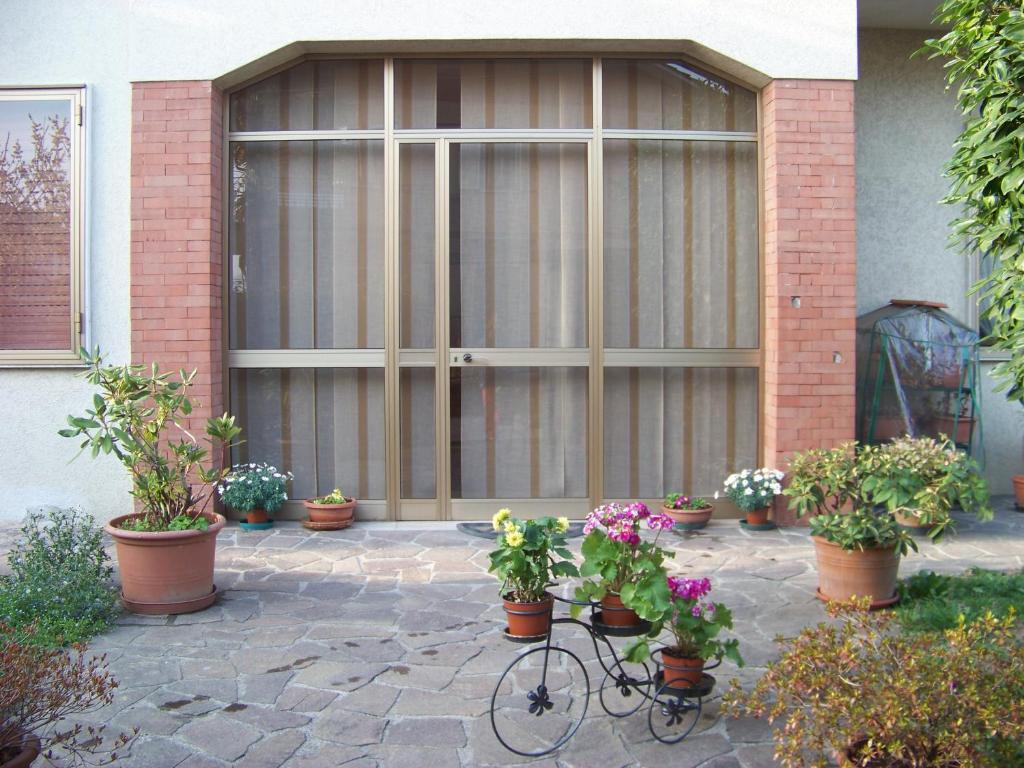 a bike parked in front of a garage with potted plants at Casa della nonna in Vicenza