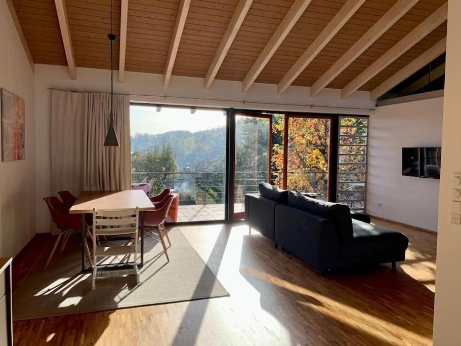 a living room with a couch and a table at Ferienloft Talblick Detmold Berlebeck in Detmold