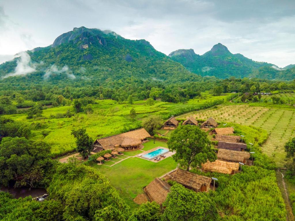an aerial view of a farm with mountains in the background at Wild Glamping Gal Oya - Thema Collection in Galgamuwa