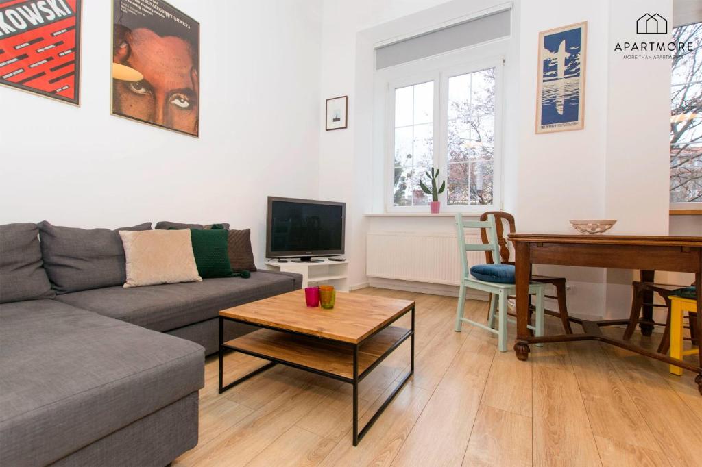 a living room with a couch and a piano at Old Town by Apartmore in Gdańsk
