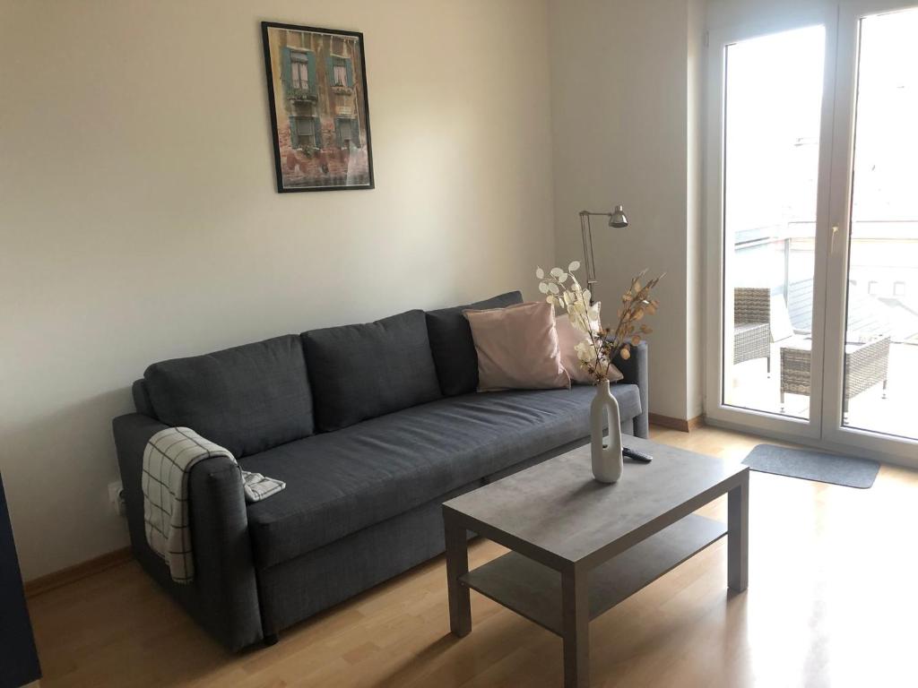 a living room with a couch and a coffee table at MF City Apartment in Korneuburg