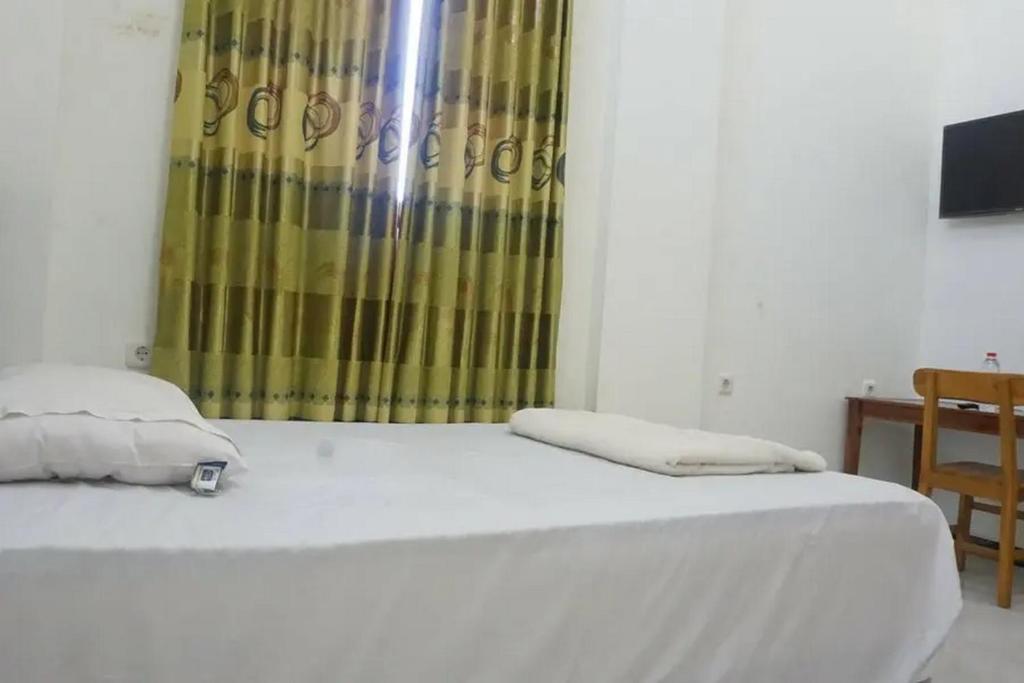 Letto o letti in una camera di Griya Mataram Kotagede Mitra RedDoorz