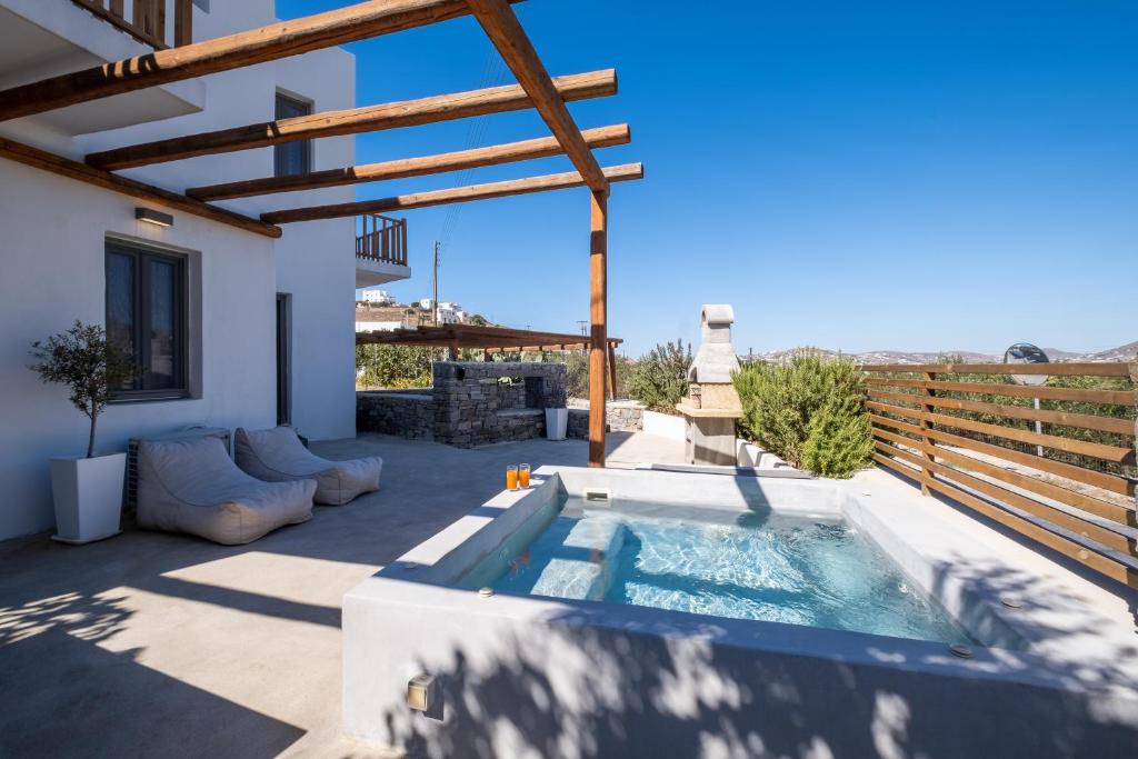 a patio with a swimming pool on top of a house at Villa Arkadia in Parasporos