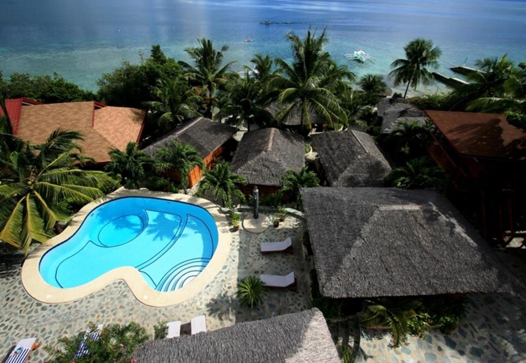 an aerial view of a resort with a swimming pool at Magic Island Dive Resort in Moalboal