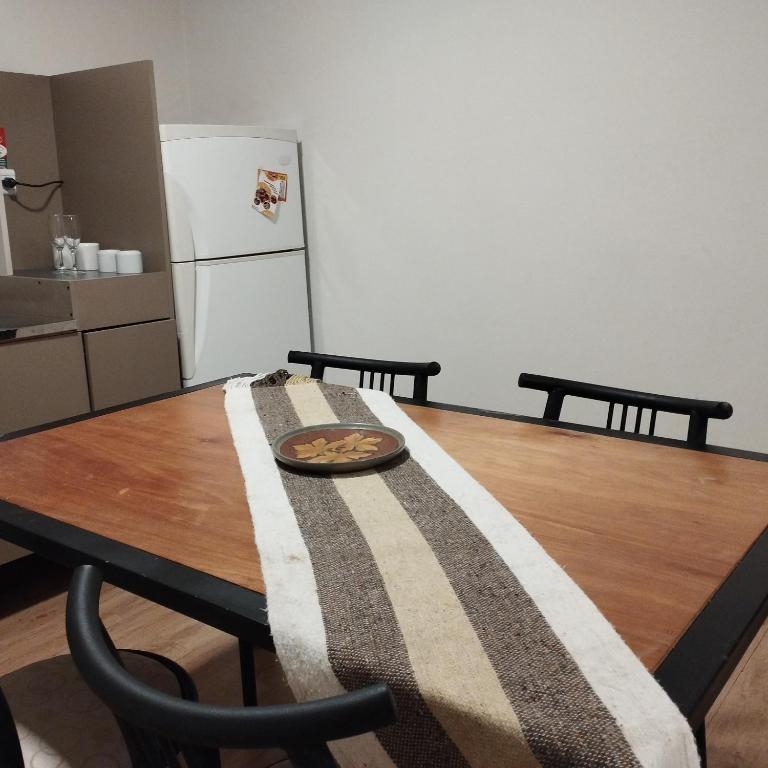 a dining room table with a plate of food on it at LAS ROSAS- Centro - 3 cuadras de la playa in Federación