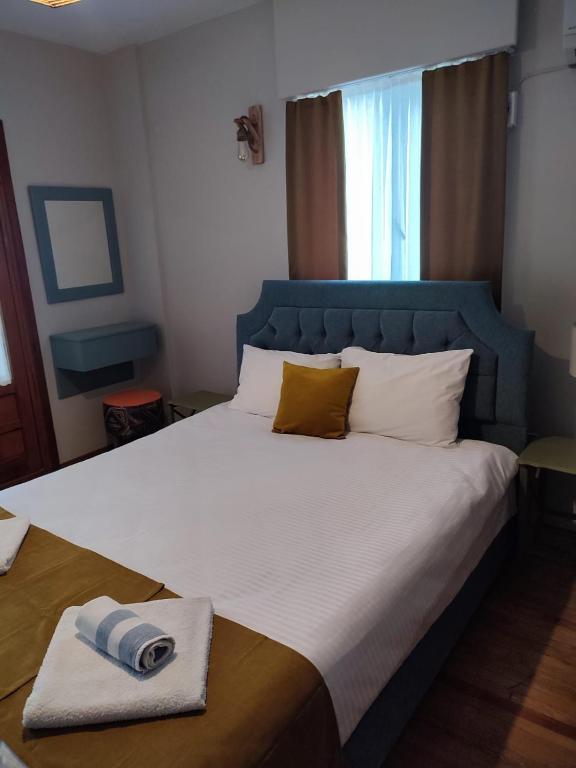 a bedroom with a large bed with a blue headboard at Balim Sultany in Çeşme