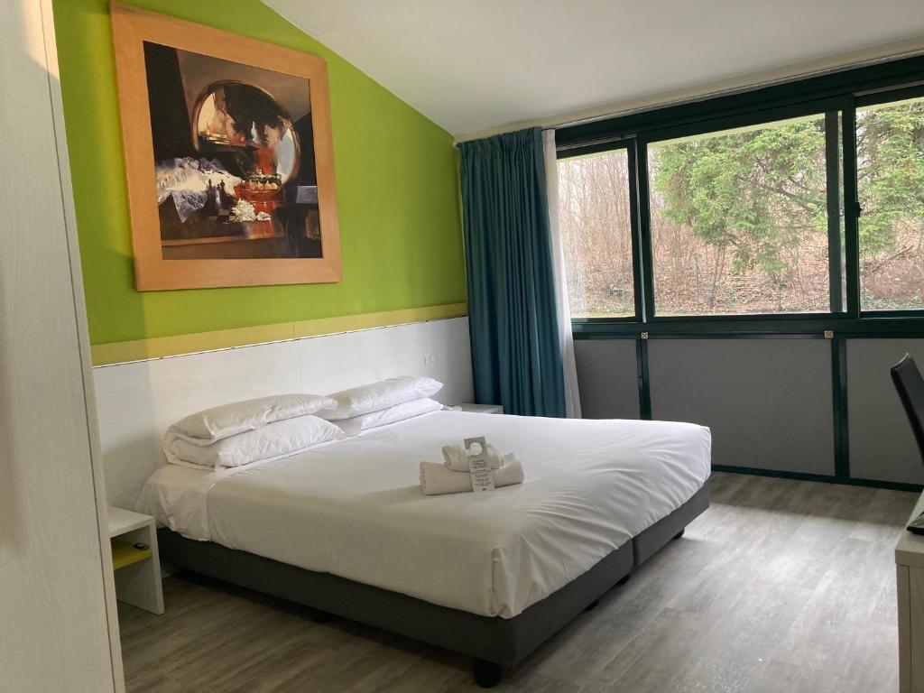 Postel nebo postele na pokoji v ubytování Green Hotel Motel