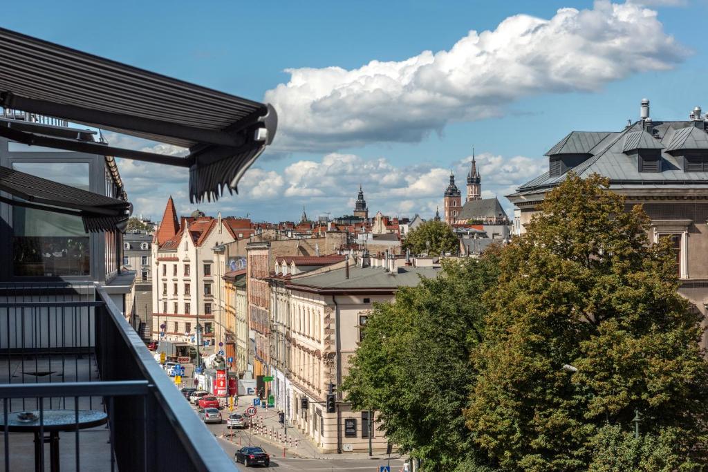 a view of a city from a balcony at InPoint Apartments G15 near Old Town & Kazimierz District & Optional Paid Parking in Krakow