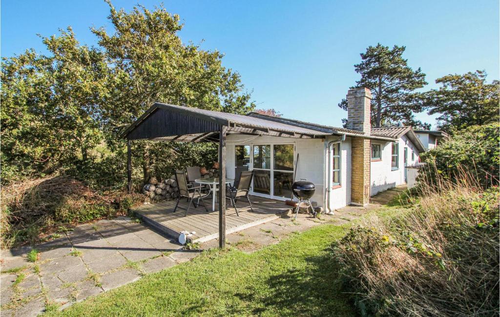 a house with a screened in porch with a grill at Awesome Home In Samsø With Wifi in Nordby
