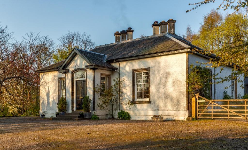 an old house with a fence in front of it at Tullich House in Keith