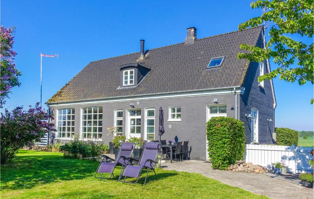 a house with purple chairs in front of it at Awesome Apartment In Rnne With 1 Bedrooms And Wifi in Rønne