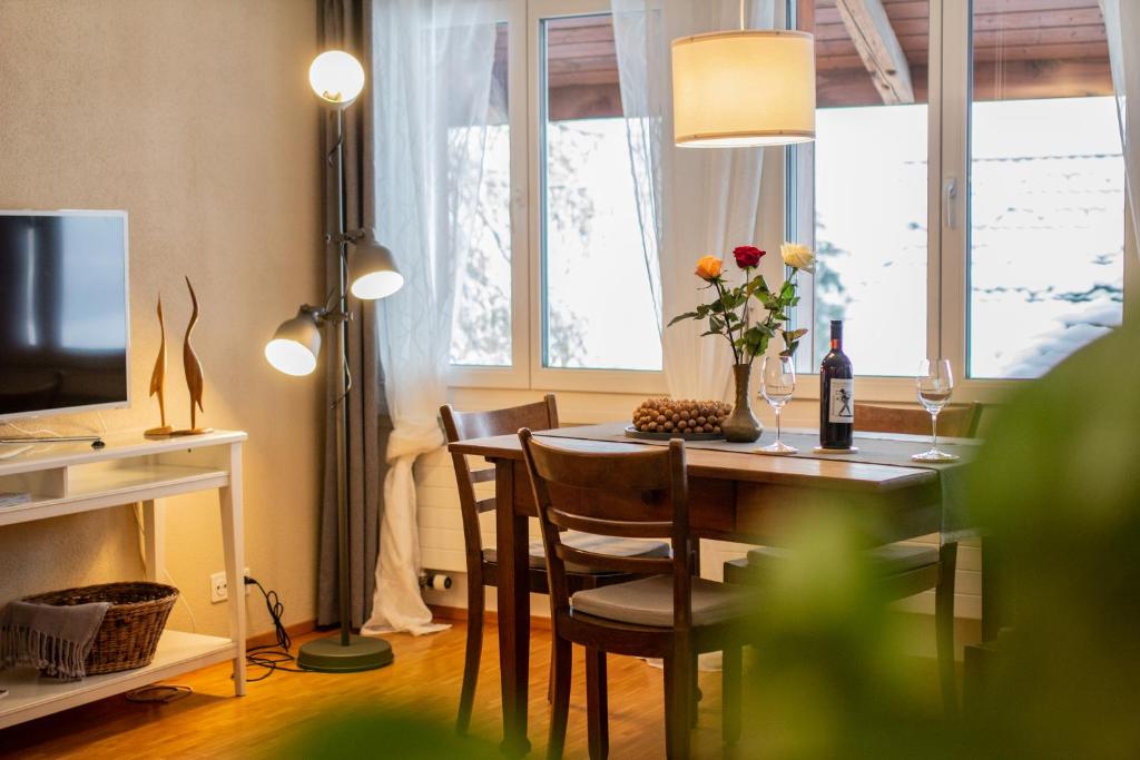 a dining room with a table with a vase of flowers at Ferienwohnung Frostenegg 