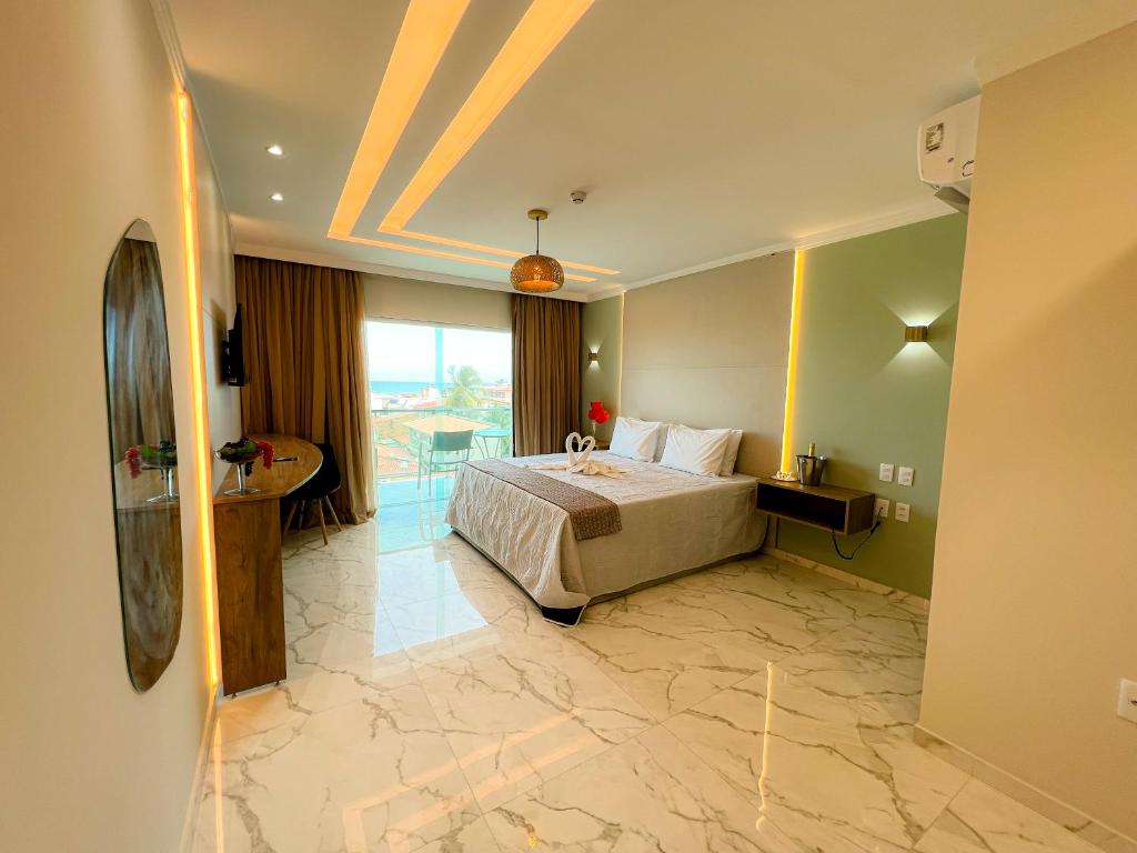 a hotel room with a bed and a balcony at Pousada Marítimos in Maragogi