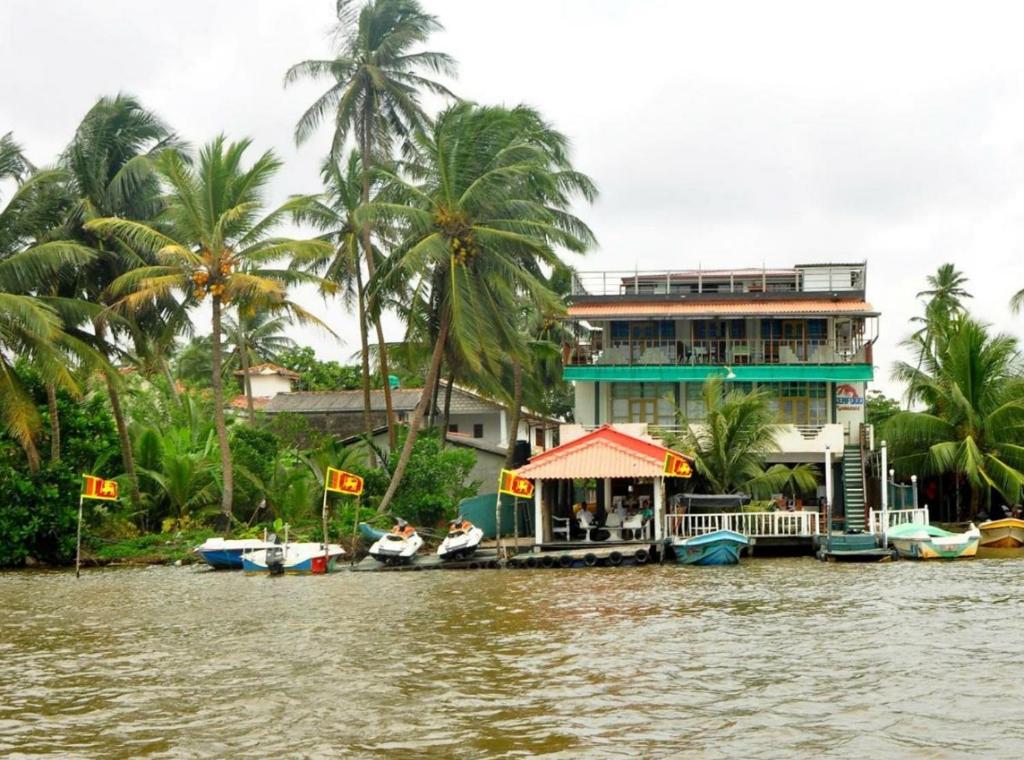 a house on the banks of a river at Luthmin River View Hotel in Alutgama