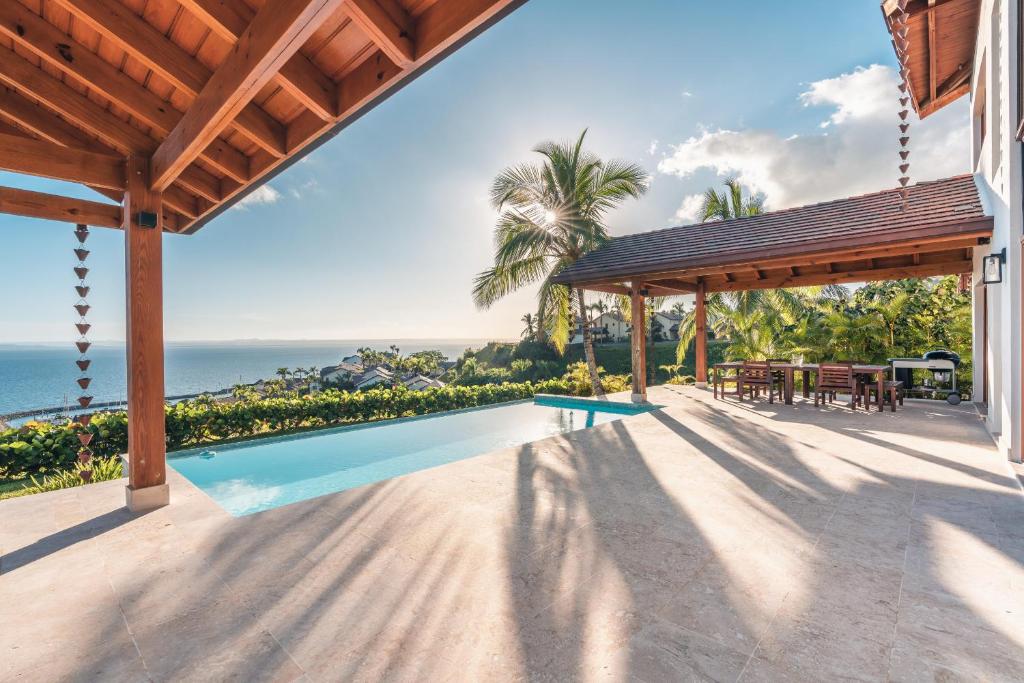 an image of a house with a swimming pool at Luxe retreat at Puerto Bahia Bkfst included in Santa Bárbara de Samaná