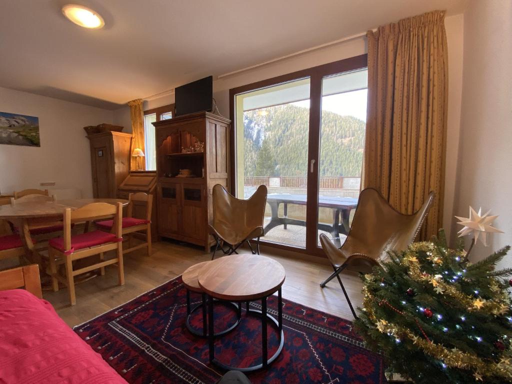 a living room with a christmas tree and a table at Chalet Jonquille in Valfréjus