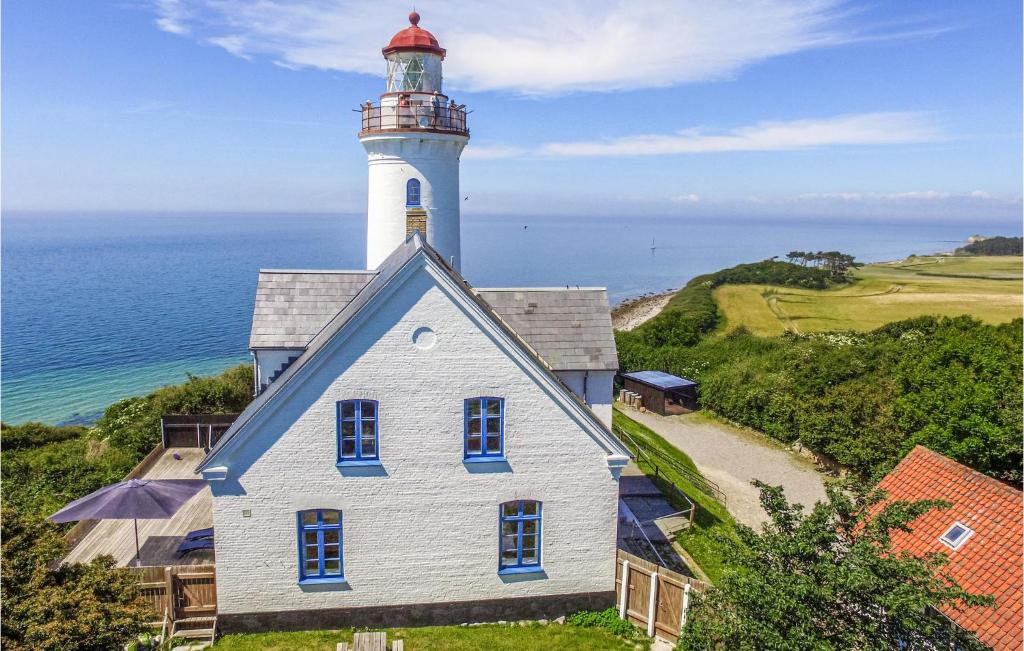 a lighthouse sits on top of a house at Amazing Apartment In Sams With Wifi in Kolby Kås