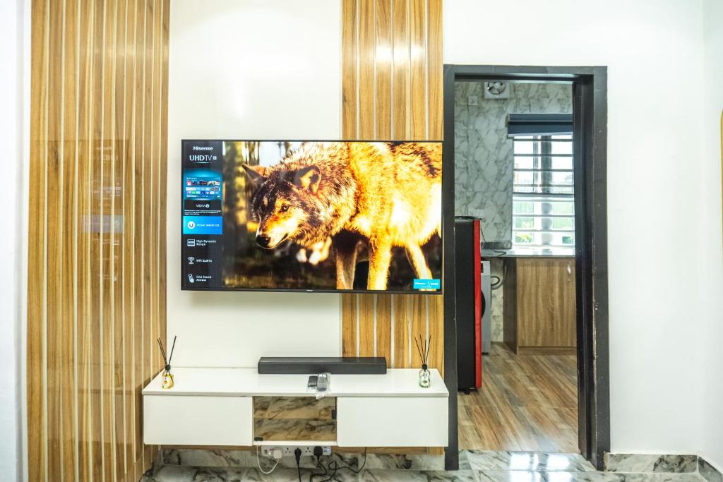 a television on a wall with a wolf on it at Lakeview 2-Bed-Apt With Amazing Views In Every Direction in Amuwo