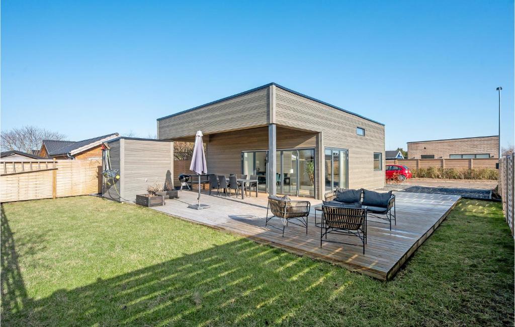 a backyard with a wooden deck with a table and chairs at Stunning Home In Hvidovre With 2 Bedrooms And Wifi in Hvidovre