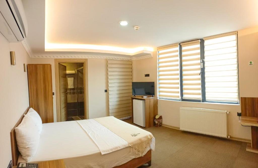 Postel nebo postele na pokoji v ubytování Osmanlı Paşa Otel- Konaklama