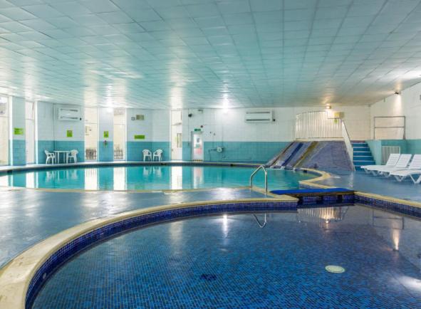 a large swimming pool in a large building at 3 Bedroom Lodge with hot tub on lovely quiet holiday park in Cornwall in Gunnislake