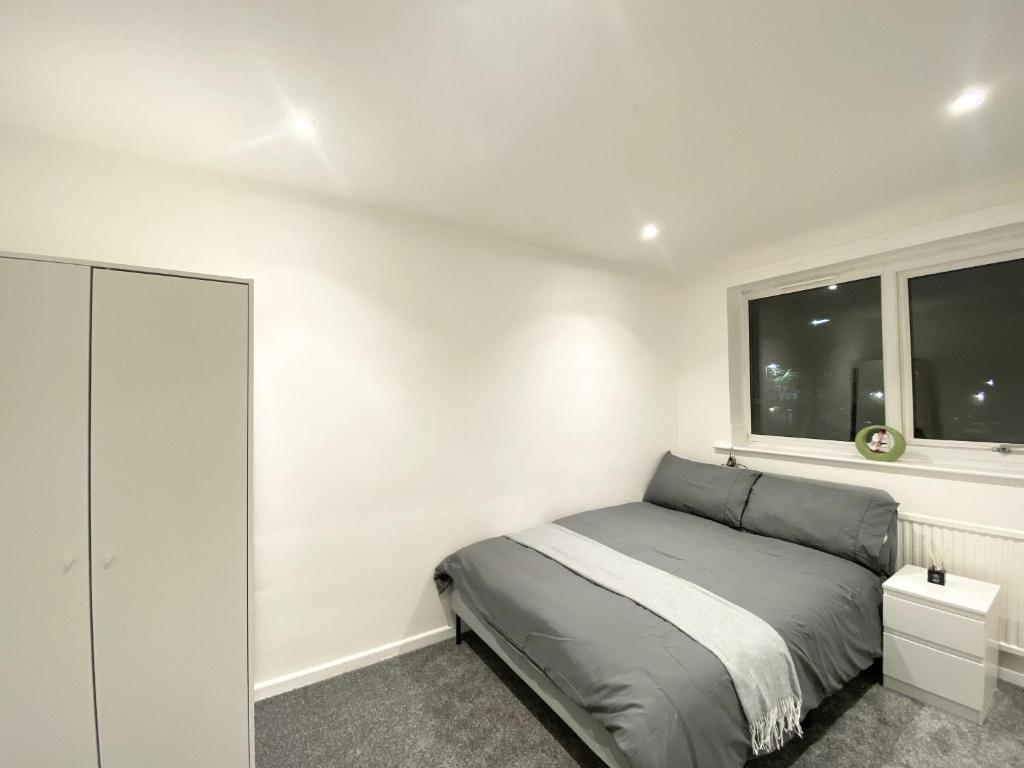 a small bedroom with a bed and a window at ThePropertyFocus - Stylish Cosy Stay in Manchester