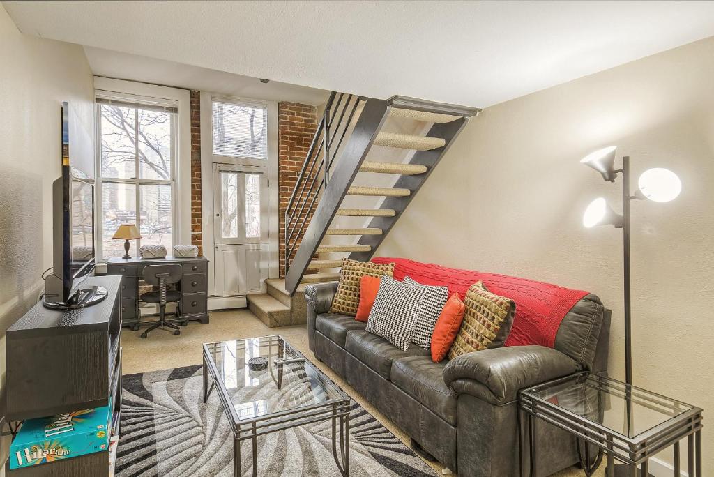 a living room with a couch and a staircase at 2193 Arapahoe St Unit 17 in Denver