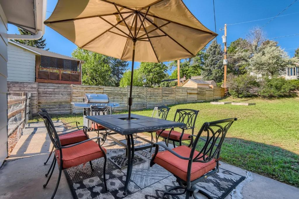 a table and chairs with an umbrella on a patio at 7213 S Tamarac St in Centennial